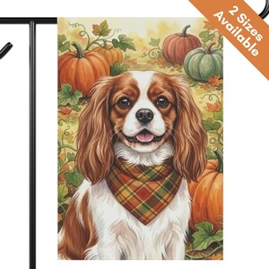 May include: A rectangular garden flag featuring a brown and white Cavalier King Charles Spaniel wearing a plaid bandana. The dog is centered against a background of orange and green pumpkins, green vines, and scattered autumn leaves in shades of yellow.