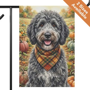 May include: A garden flag featuring a fluffy gray dog wearing a plaid bandana in orange, yellow, and brown. The background shows a pumpkin patch with various pumpkins and autumn foliage. The top corner includes an orange banner with the text 2 Sizes Available.