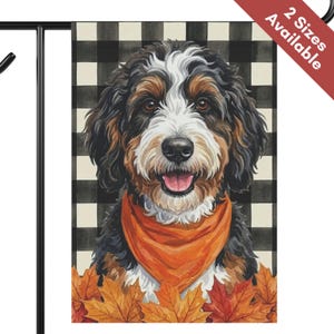 May include: A rectangular garden flag featuring a portrait of a Bernese Mountain Dog mix with black, brown, and white fur, wearing an orange bandana. The dog is positioned in front of a black and white buffalo check pattern with autumn leaves.
