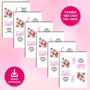 May include: Printable table cards with pink floral designs and instructions for a game. The cards are numbered 1 through 6 and include the text "Winners: Move to Table... Switch Partners" and "Losers: Stay".
