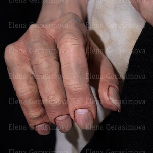 Puede incluir: Primer plano de una mano con piel arrugada y u&ntilde;as cortas y recortadas. La mano es p&aacute;lida y tiene venas visibles.