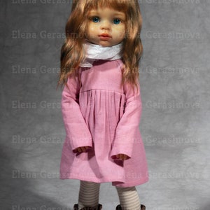May include: A doll with long, wavy, auburn hair, blue eyes, and freckles wearing a pink dress, white scarf, and brown boots.