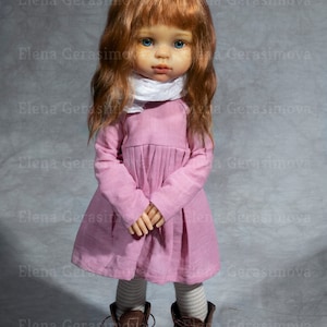 May include: A doll with long, wavy, auburn hair, wearing a pink dress, white scarf, and brown boots. The doll has blue eyes and a freckled face.