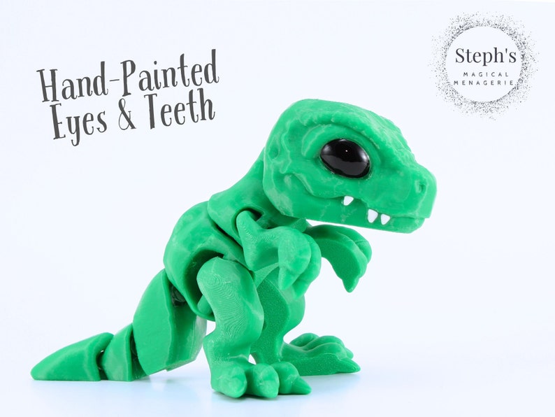 May include: A green articulated dinosaur figurine with hand-painted eyes and teeth. The figurine has a textured surface and is posed on a white background. The text "Hand-Painted Eyes & Teeth" is visible.