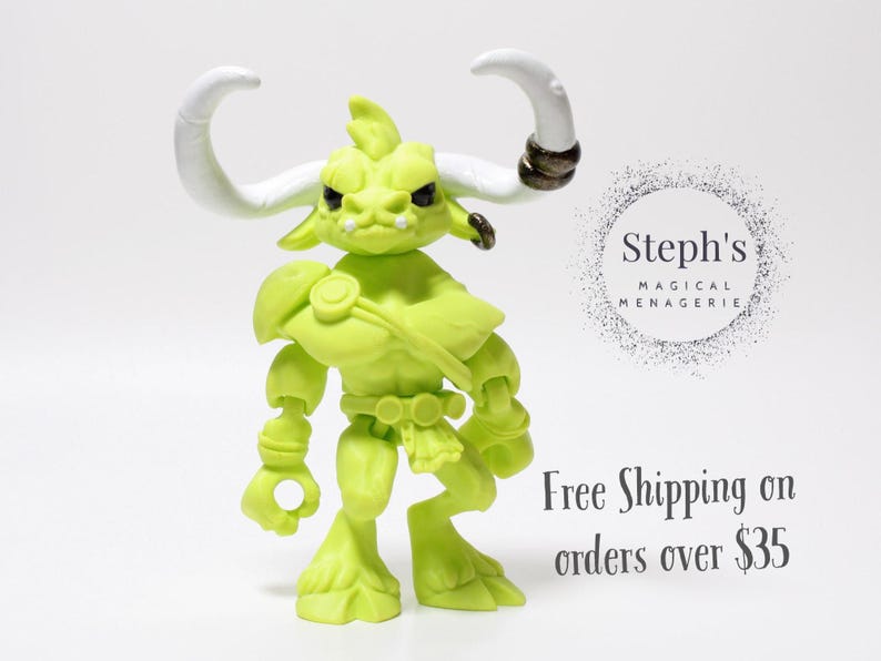 May include: A lime green action figure of a horned creature with white horns and a stern expression. The figure has armor-like details and is posed against a white background. The text "Steph's Magical Menagerie" is visible.