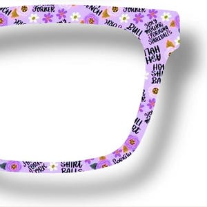 May include: A pair of eyeglasses with a light purple frame. The frame is decorated with a floral pattern of white and purple flowers, and text that reads "SHINE RAILS", "JOKER", and "ASH HOLE".