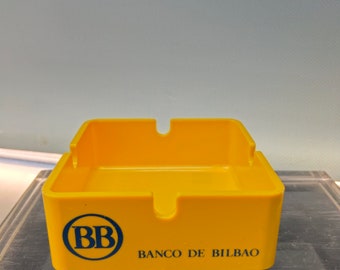 Cendrier publicitaire Banco de Bilbao, jaune. plastique, design
