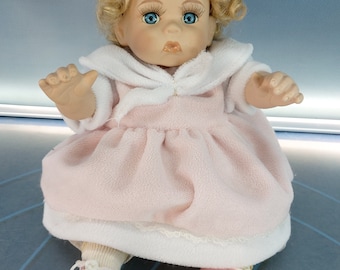 Automaton baby, porcelain doll with wind-up: music plays and moves.