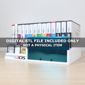 May include: A white plastic display stand for Nintendo 3DS games and a console. The stand features the Nintendo 3DS logo on the front. The text DIGITAL STL FILE INCLUDED ONLY NOT A PHYSICAL ITEM is printed across the center of the image.