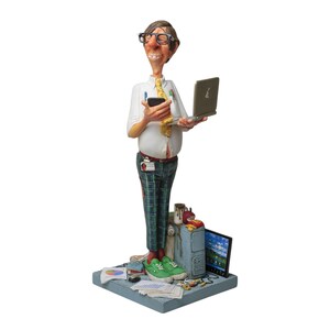 May include: A figurine of a man wearing glasses, a white shirt, green and red plaid trousers, and green shoes. He is holding a laptop and a mobile phone. The figurine is standing on a base with a computer monitor, a keyboard, and other office supplies.