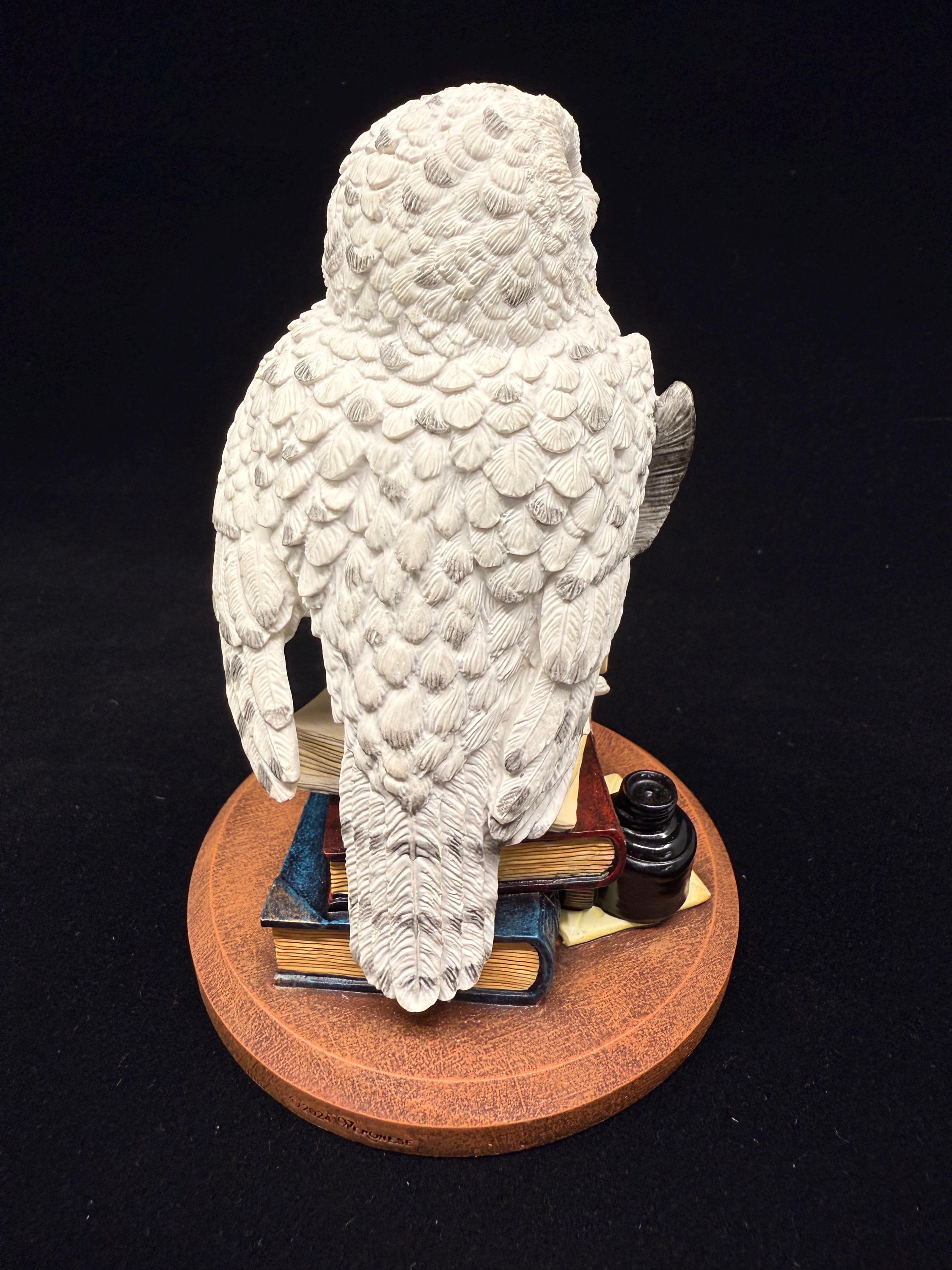 本に乗ったシロフクロウの置物 - 手作りの魔法のデスクデコレーション