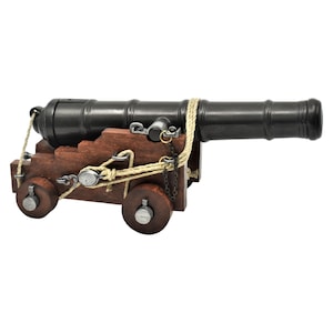 May include: A black metal cannon on a wooden carriage with rope and chain details. The cannon is mounted on two wooden wheels.