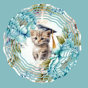 May include: A watercolour illustration of a kitten wearing a graduation cap, set within a floral wreath of blue and pink flowers. The image has a light blue background and a wavy border.