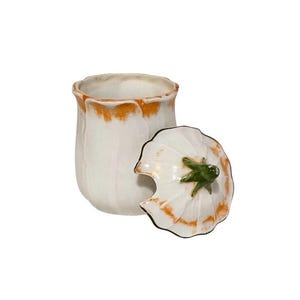 May include: White ceramic sugar bowl with a lid shaped like a flower. The lid has a green stem and leaves.