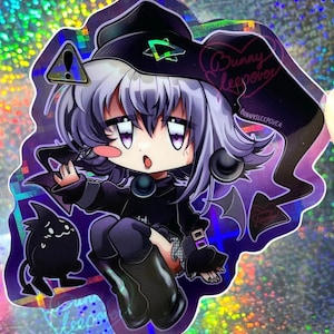 May include: A holographic sticker featuring a cartoon character with purple hair, wearing a black hat and outfit. The character has a surprised expression and is holding a small black creature. The sticker has the text "Bunny Sleepover" and "@BUNNYSLEEPOVER" on it.