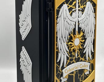 May include: A black book with white wing designs on the side and front. The front cover features a gold border, white wings, a sword, and the text "Celestial Codex" on a banner. The book is open, revealing the interior.