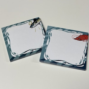May include: Two blue and white patterned sticky note pads with a fish and a shrimp illustration. The sticky notes are blank and ready to write on.