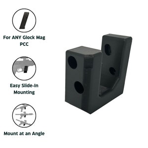 May include: Black plastic wall mount for a Glock magazine. The mount has two holes on the side and one on the back for mounting. The mount is designed to hold the magazine at an angle.