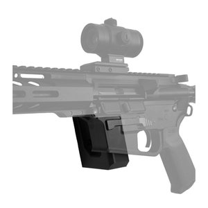 May include: A black AR-15 style rifle with a black and gray magazine and a red dot sight. The rifle has a black polymer grip and a black metal barrel.
