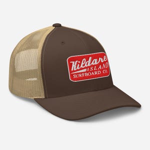 May include: Brown and tan trucker hat with a red patch that says "Kildare Island Surfboard Co."