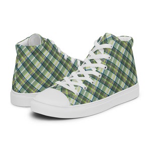 May include: White high-top canvas trainers with a green, yellow and blue plaid pattern.