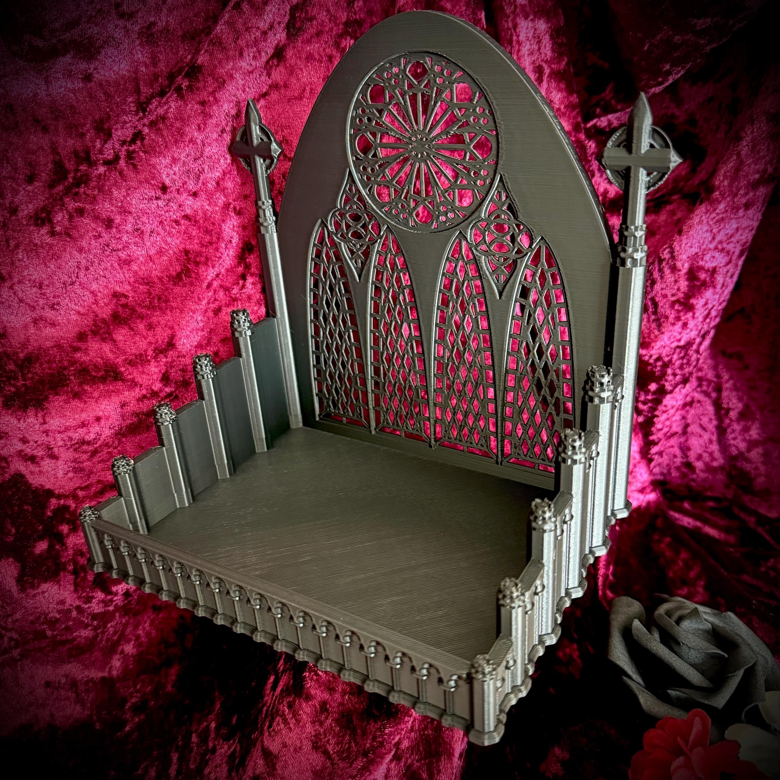 Gothic-style miniature accessory tray with cathedral-like spires and rose window details, set against red velvet fabric
