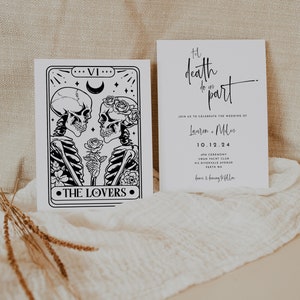 May include: Two white wedding invitation cards. One card features a black and white tarot card design with skeletons and the text "THE LOVERS". The other card has the text "Til death do us part" and wedding details.