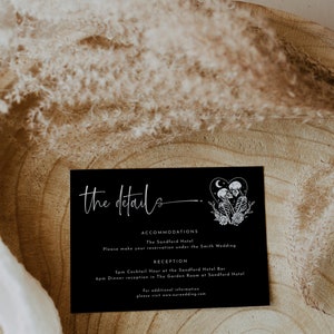 May include: Black and white wedding details card with the text "the details" in white script font. The card includes information about accommodations at The Sandford Hotel and a reception at The Sandford Hotel Bar and The Garden Room. The card also includes a graphic of two skeletons holding hands with a crescent moon and stars above them.