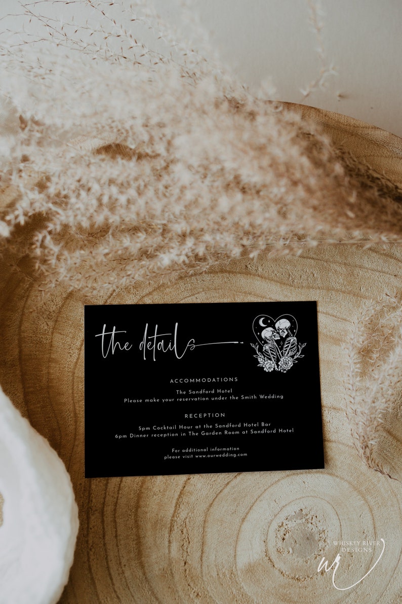 May include: Black and white wedding details card with the text "the details" in white script font. The card includes information about accommodations at The Sandford Hotel and a reception at The Sandford Hotel Bar and The Garden Room. The card also includes a graphic of two skeletons holding hands with a crescent moon and stars above them.