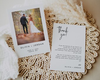 May include: A wedding thank you card with a simple design. The card features a black and white photograph of a couple holding hands and walking away from the camera. The text on the card reads "Thank you!" and includes a message from the couple thanking guests for celebrating their special day. The card is printed on white cardstock and has a simple, modern design.