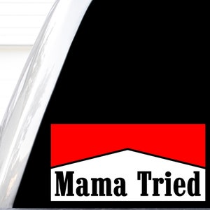 May include: A red and white sticker with the text "Mama Tried" in black letters. The sticker is designed to look like a cigarette pack.