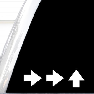 May include: A black decal featuring three white arrows arranged in a horizontal row. The first two arrows point to the right, while the third arrow on the far right points upward. The design is simple, clean, and consists of solid white shapes.