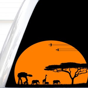May include: A black sticker featuring an orange sunset silhouette. The scene depicts a large acacia tree, two elephants, a giraffe, and a four-legged mechanical walker walking across the horizon. Two starfighter silhouettes fly in the sky.