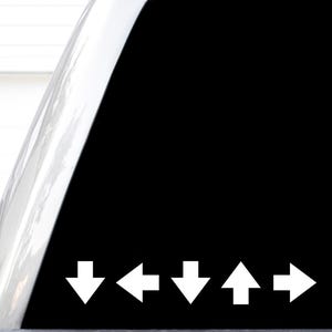 May include: A black rectangular decal featuring a series of five white directional arrows arranged in a horizontal row. The sequence consists of a downward arrow, a leftward arrow, a downward arrow, an upward arrow, and a rightward arrow.