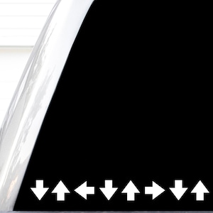 May include: A black decal featuring a horizontal row of eight white arrows pointing in alternating directions. The sequence of arrows points down, up, left, down, up, right, down, and up, creating a geometric pattern on a solid black background.