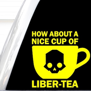 May include: A black sticker featuring a yellow graphic of a teacup with a black skull icon in the center. The text in yellow reads HOW ABOUT A NICE CUP OF LIBER-TEA, with the word LIBER-TEA positioned below the teacup graphic.