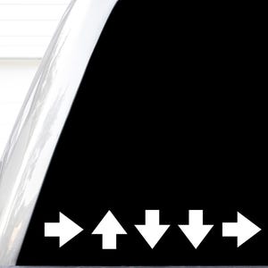 May include: A black decal featuring a sequence of five white arrows. The first arrow points to the right, the second points upward, the third points downward, the fourth points downward, and the fifth points to the right, arranged in a row.