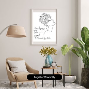 May include: Black and white line art print of a woman with flowers in her hair. The quote "You deserve to take up space." by Chimamanda Ngozi Adichie is printed below the image. The print is framed and hanging on a white wall.