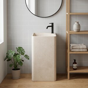 May include: A modern bathroom scene featuring a beige pedestal sink with a black faucet. A round black mirror hangs above the sink. A wooden shelf holds towels, a vase, and a soap dispenser. A potted plant adds a touch of greenery.