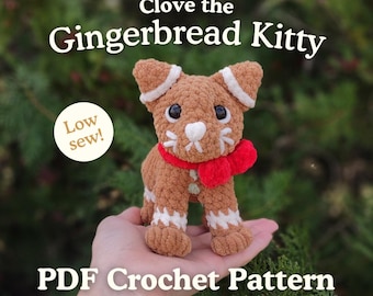 May include: A crocheted gingerbread cat with white accents, a red scarf, and black eyes. The text "Clove the Gingerbread Kitty" and "Low sew!" are displayed. The words "PDF Crochet Pattern" are also visible.