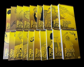 May include: A stack of 19 yellow and white manga volumes of Banana Fish by Akimi Yoshida. The spines of the books feature a black and white illustration of a character with a cigarette.