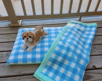 Small dog bed/cushion with removable/washable cover with matching blanket.