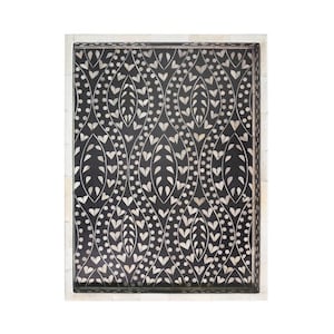 May include: A black and white bone inlay tray with a decorative pattern of leaves and dots. The tray has a white border.