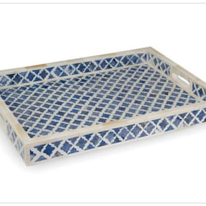 May include: A rectangular serving tray with a blue and white geometric pattern. The tray is made of bone inlay and has a raised border.