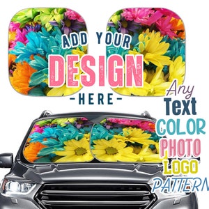 May include: A pair of car sunshades with a floral design. The sunshades are yellow, blue, pink, and orange. The text "ADD YOUR DESIGN HERE" is printed on the sunshades.