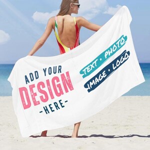 May include: White beach towel with the text "ADD YOUR DESIGN -HERE-  TEXT. PHOTO IMAGE. LOGO" in colourful, stylized lettering.
