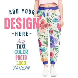 May include: A pair of white sweatpants with a floral embroidery pattern. The sweatpants have a blue waistband and blue cuffs. The text "ADD YOUR DESIGN - HERE - Any Text COLOR PHOTO LOGO PATTERN" is visible on the left side of the image.