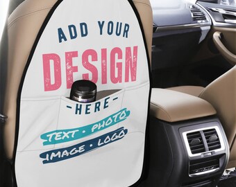 May include: White car seat back protector with a black border. It has a pocket with the text "ADD YOUR DESIGN - HERE - TEXT - PHOTO - IMAGE - LOGO" in blue and pink.