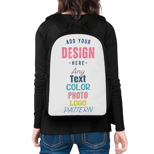 May include: Black backpack with a white front panel. The panel features text in various colors: "ADD YOUR DESIGN - HERE - Any Text COLOR PHOTO LOGO PATTERN". The backpack has black straps and side pockets.