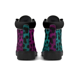 May include: A pair of black leather boots with a pink and teal leopard print design. The boots have a lace-up closure and a round toe.